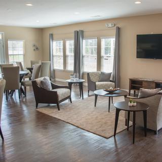 A modern living room with a cozy seating arrangement and adjacent dining area.