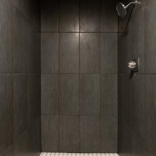A modern tiled shower with a sleek design.