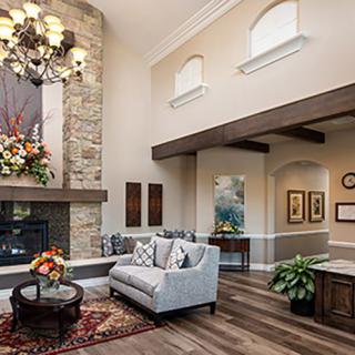 Elegant living room with a stone fireplace and stylish decor.