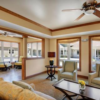 A modern and spacious living room with comfortable seating and ample natural light.
