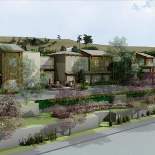 A row of modern residential houses surrounded by landscaped greenery.