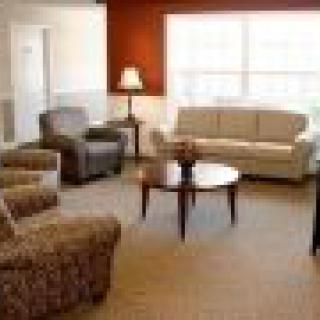 A cozy living room with a sofa, chairs, and a coffee table.
