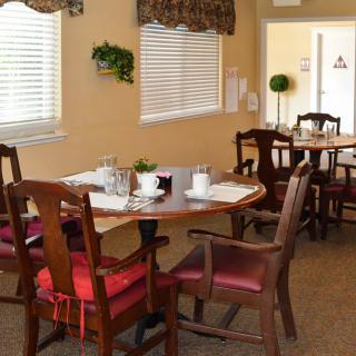 A cozy dining area with neatly arranged tables and chairs, perfect for enjoying a meal indoors.