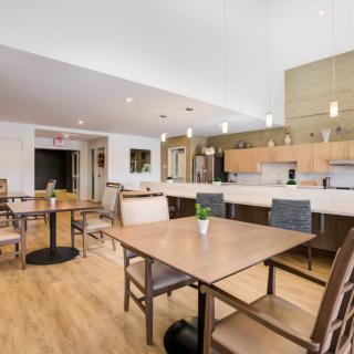 A modern kitchen and dining area with wood flooring, featuring a bright and open design.