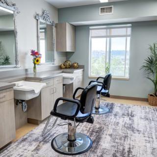 A modern hair salon interior with styling chairs and mirrors.