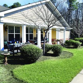 A cozy house with a well-maintained lawn and front porch.