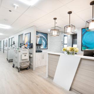 A modern and welcoming reception area in a medical facility, featuring contemporary design and bright lighting.
