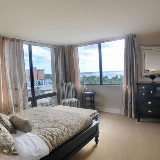 A modern bedroom with large windows offering a scenic view.
