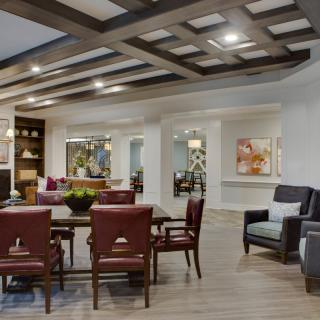 A modern living room with stylish furniture and a coffered ceiling.