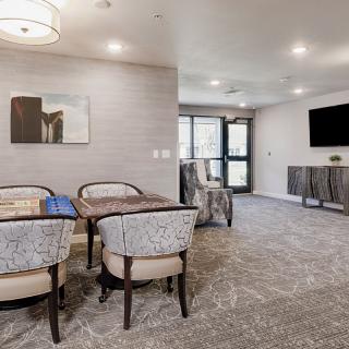 A modern living room with a seating area, television, and stylish decor.