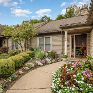 A charming residential home with a beautifully landscaped garden and colorful flowers.