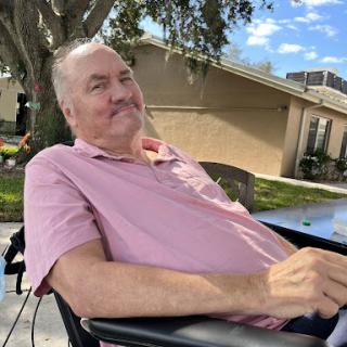 A cheerful man enjoying a sunny day outside.