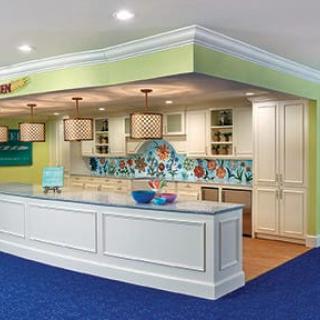 A modern kitchen with a colorful backsplash and elegant lighting.