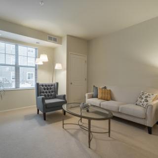 A cozy and inviting living room setup featuring a comfortable sofa, an elegant armchair, and a stylish coffee table.