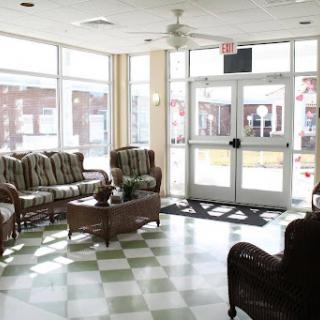 A bright and spacious lobby featuring comfortable seating and large windows.