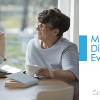 Two people having a casual discussion over coffee in a bright setting.