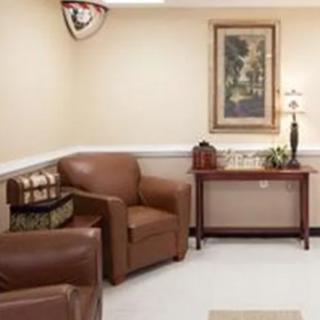 A cozy waiting room with leather chairs and a side table.