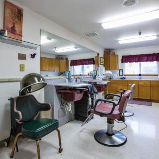 Interior of a classic barbershop with chairs, mirrors, and hair styling equipment.