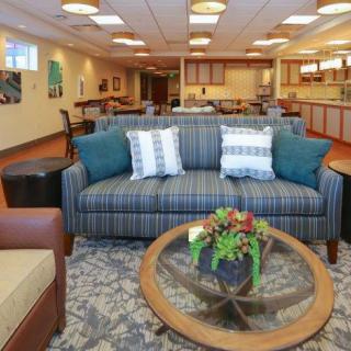 A spacious and well-decorated living room featuring a comfortable sofa, stylish coffee table, and tasteful decor.