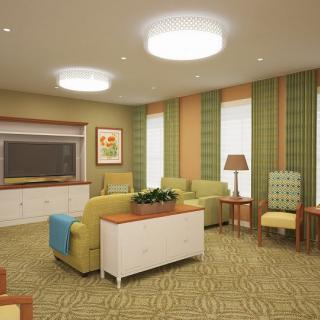 A modern living room with comfortable seating and warm lighting.