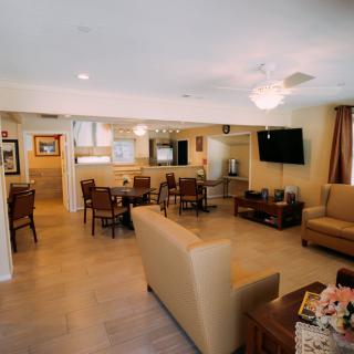 A cozy living room with comfortable seating, a mounted television, and elegant decor.