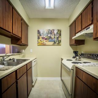 A compact kitchen with wooden cabinets and modern appliances.