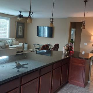 A modern open-concept kitchen with a central island and adjacent living room area.