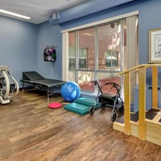 A rehabilitation space equipped with exercise machines and therapy tools.