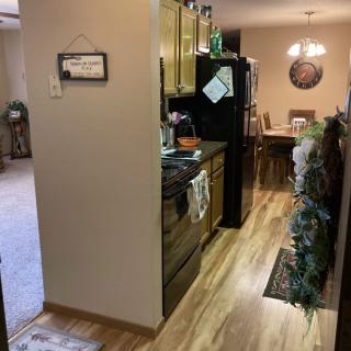 A modern kitchen and dining area with wood flooring and stylish decor.