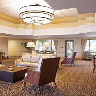 A spacious lobby with elegant seating and a large chandelier.