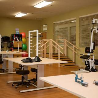 A well-equipped physical therapy room with various exercise and rehabilitation equipment.