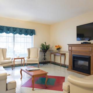 A cozy living room with comfortable seating and a fireplace.