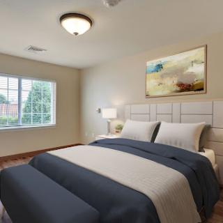 A cozy and elegantly designed bedroom featuring a comfortable bed, stylish decor, and natural light.