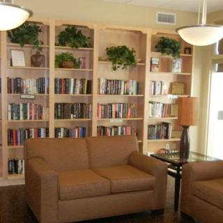 A cozy reading area with sofas and bookshelves filled with books.