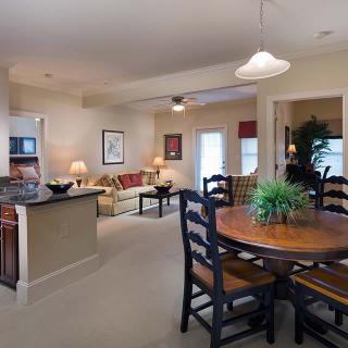 A cozy living space featuring an open floor plan with a dining area and kitchen.