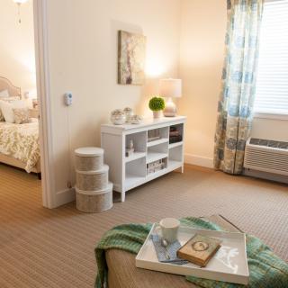 A cozy and modern living room with light-colored decor and furniture.