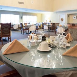 A well-set dining table in a spacious restaurant interior.