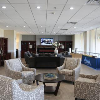 A spacious lobby with comfortable seating and a television.