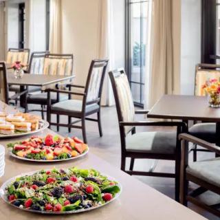 A restaurant dining area featuring a display of fresh salads and appetizers.
