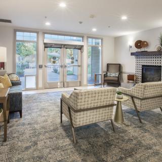 A modern lobby with comfortable seating and a fireplace.
