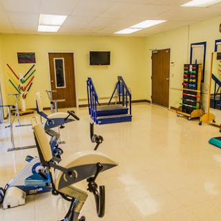 A well-equipped physiotherapy and rehabilitation room featuring various exercise machines and tools for patient recovery.
