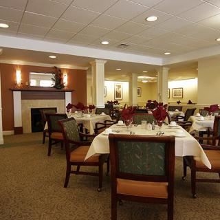 An elegant dining area with neatly arranged tables and chairs, creating a formal and inviting atmosphere.