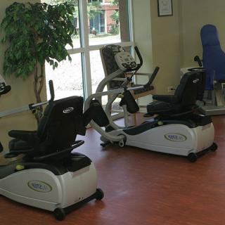 A fitness room with recumbent bikes and exercise equipment.