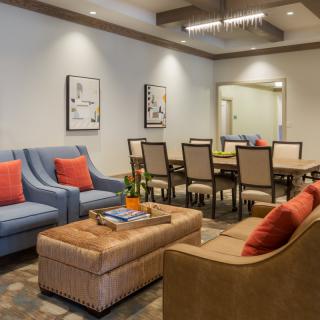 A stylish living and dining area featuring modern furniture and artwork.