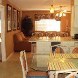 A cozy kitchen and dining area with warm colors and comfortable seating.