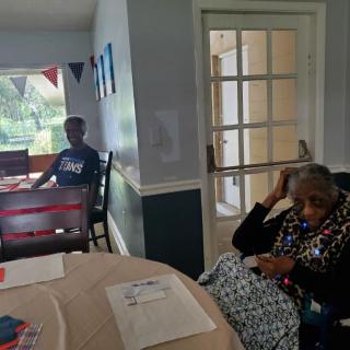 Two people relaxing in a decorated living room.