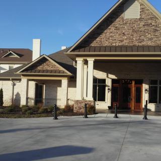 A view of a modern building with stone and stucco exterior.