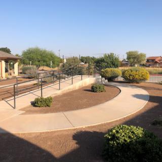 A serene outdoor space featuring a curved pathway surrounded by well-maintained landscaping.