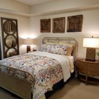 A cozy bedroom with stylish decor and ambient lighting.