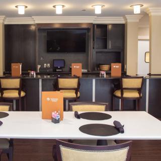A modern restaurant interior featuring bar seating and elegant lighting.
